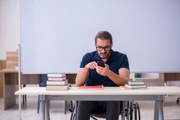 Young male handicapped student in the classroom