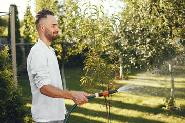 Man watering grass in the garden