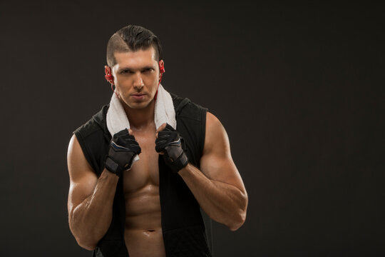 Portrait of muscular man wearing sports gloves