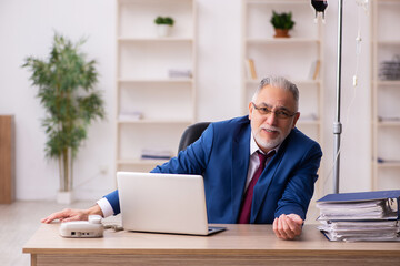 Fototapeta premium Old male employee in blood transfusion concept