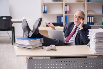 Aged male employee and too much work at workplace