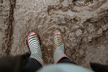 Close-up of rubber boots in a swamp top view.