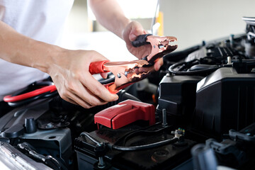 Car maintenance technician He is checking the auto engine, car inspection center.