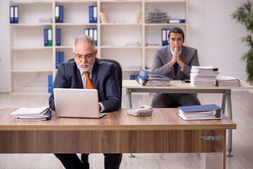 Two employees sitting at workplace