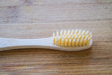 Toothbrush made of bamboo on a wooden background