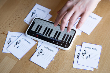 Close-up of cards for studying music and piano in the phone.