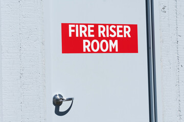 Fire Riser Room sign on the door leading to dedicated space for fire protection equipment