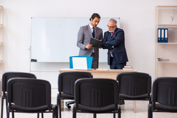 Two businessmen in the classroom in pandemic concept