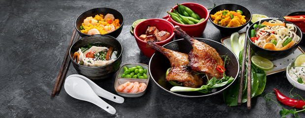 Assorted Chinese dishes and snacks on dark gray background. Traditional food concept.