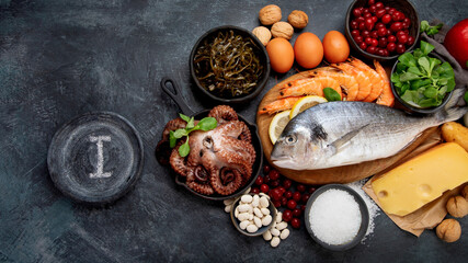 Food high in iodine on dark gray background. Healthy eating concept.