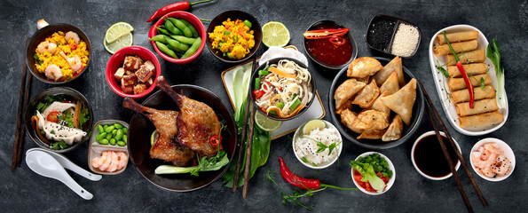 Assorted Chinese dishes and snacks on dark gray background. Traditional food concept.