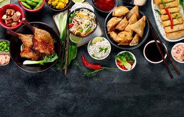 Assorted Chinese dishes and snacks on dark gray background. Traditional food concept.