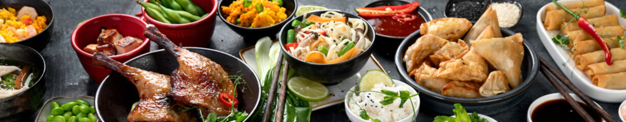 Assorted Chinese dishes and snacks on dark gray background. Traditional food concept.