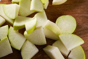 sliced white radish on a wooden board