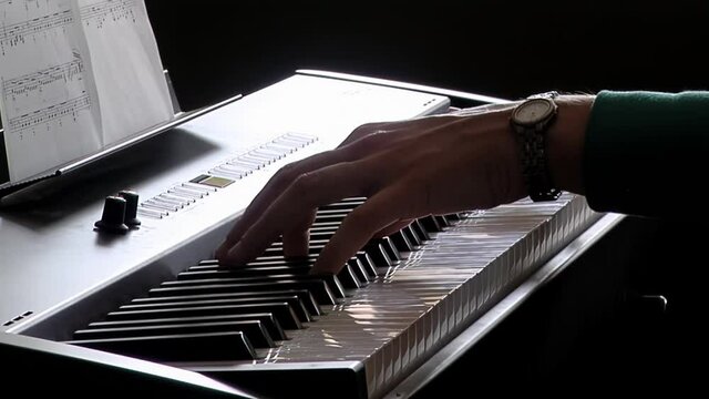 Hands of a Young Woman playing the Electronic Piano. Close Up. 