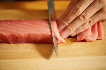 Cutting fresh tuna with a sashimi knife