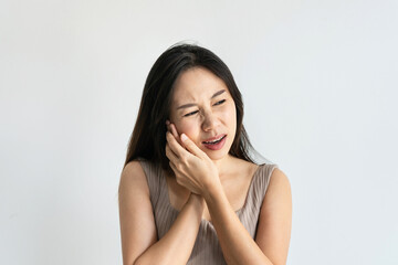 Asian woman feeling teeth pain. Closeup of sad girl suffering from toothache. Beautiful female feeling painful toothache on white background. Dental health and care, teeth problem concept. Copy space