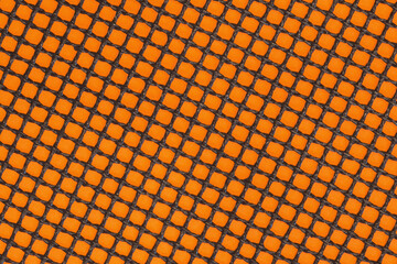 Non-stick fibreglass grill mat arranged in a diagonal position on the orange background