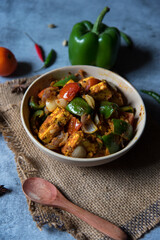  Kadai Paneer a semi dry curry made with Indian cottage cheese, onions tomatoes and green bell peppers. Top view.