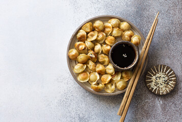 Chocolate muffin, candies and cinnamon sticks on brown plate. Flat lay