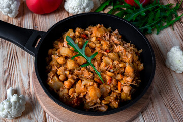 Homemade chicken stew with vegetables, potato, onion, carrot, cauliflower, pepper with tomato...
