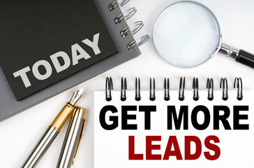 On the table are a pen and notebooks with the words - Today and Get More Leads