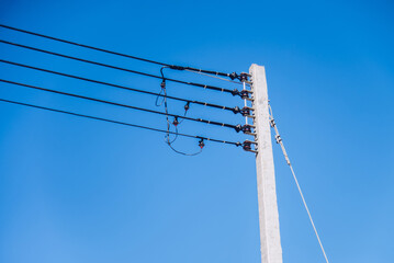 Single electric pole and cable with blue sky for background concept idea