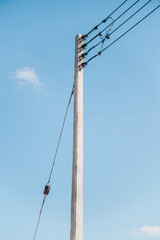 Single electric pole and cable with blue sky for background concept idea