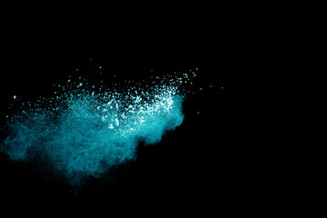 Abstract splash of green colored powder on black background.Green powder explosion.