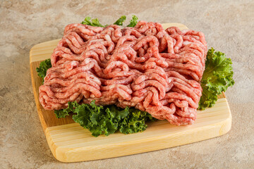 Raw pork minced meat over board