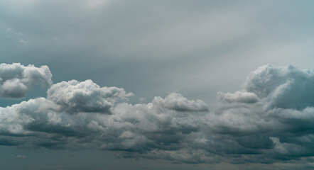 Panorama view of overcast sky. Dramatic gray sky and white clouds before rain in rainy season. Cloudy and moody sky. Storm sky. Cloudscape. Gloomy and moody background. Overcast clouds.