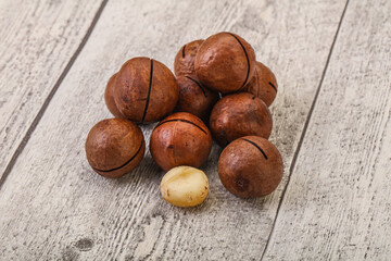 Brown macadamia nut heap over background