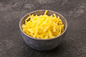 Shredded yellow cheese in the bowl