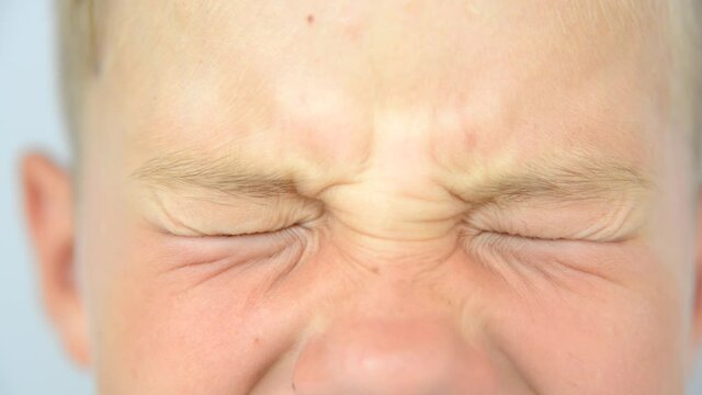 CLose up boy closes his eyes 