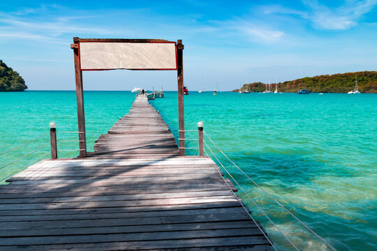 Landscape of seascape with wooden bridge in the sea at Koh Kood is a tropical island with emerald green water and beautiful beaches amidst clear blue sky.