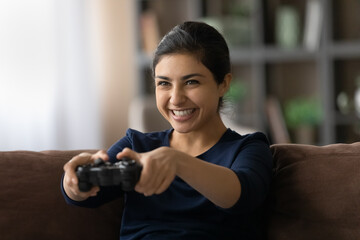 Video gamer. Passionate excited indian female teenager play favorite console videogame spending...