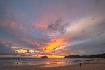 Obraz premium Scene of Colorful romantic sky sunset with Changing the color of the sky background . .beautiful cloud at sunset above island in nature and travel concept..
