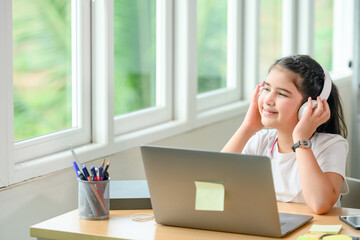 student girl smiling happily she is cheerful Glad to study online with a tutor for education while waiting for the school to open. Concept : Enjoy online learning.