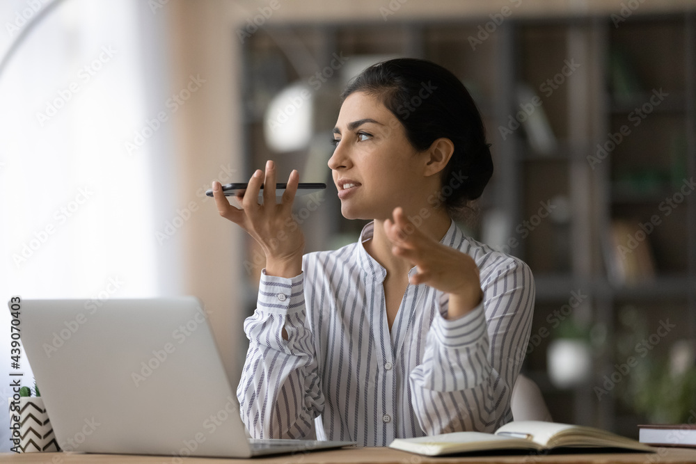 Wall mural concentrated young mixed race female employee scientist record work results using smartphone transla