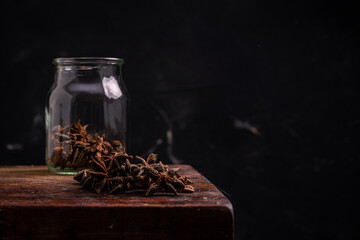 star anise on wood and dark background