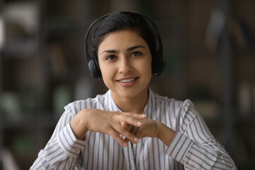 Customer service. Webcam portrait of friendly indian female in headset client support specialist speak talk look at camera. Young ethnic woman hr make video call to applicant for distant job interview