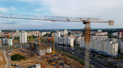 Fototapeta na wymiar Aerial view of the new urban development. New houses are being built. The cranes are visible.