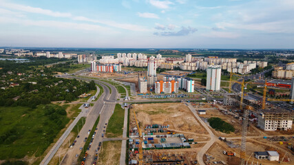 Fototapeta na wymiar Aerial view of the new urban development. New houses are being built. The cranes are visible.