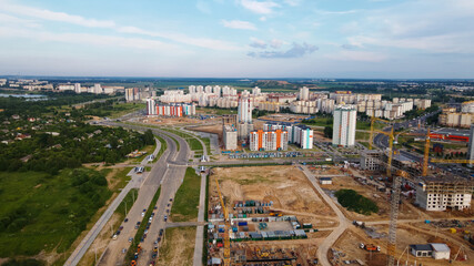 Obraz premium Aerial view of the new urban development. New houses are being built. The cranes are visible.
