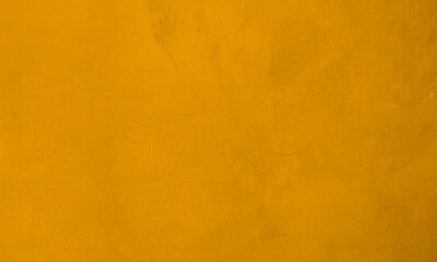Texture of modern concrete wall painting gold yellow for background.