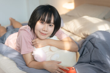 Obraz na płótnie Canvas Portrait young adult asian woman relax in bedroom on morning.