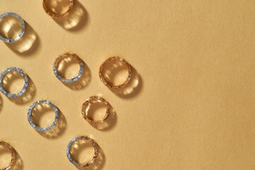 Collection of clear resin rings lying falt on orange