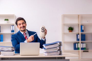 Naklejka premium Young male employee unhappy with excessive work in the office