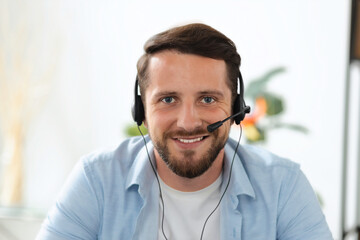 Portrait of handsome young manager or call center worker in headset looking at the webcam, having online meeting client Head shot of friendly smiling hotline employee, online consultation, video call