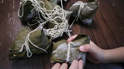 holding Zongzi in hand design for miss concept Zongzi is the traditional food made by glutinous rice at Dragon Boat Festival in Taiwan
